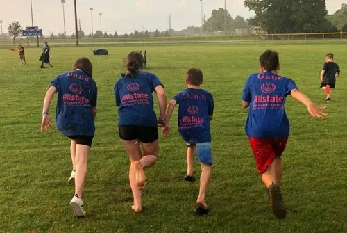 Goines Agency volunteers and young community members head onto the field together for a day of fun.