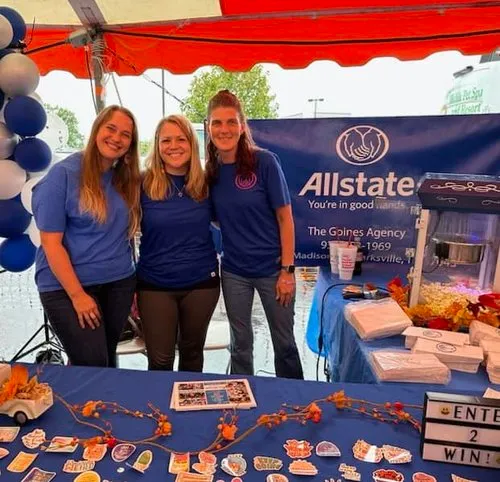 Alexis Goines and the Goines Agency team welcome neighbors to an Allstate community booth.