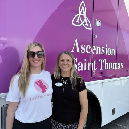 Alexis Goines joins a community partner outside the Ascension Saint Thomas mobile unit.