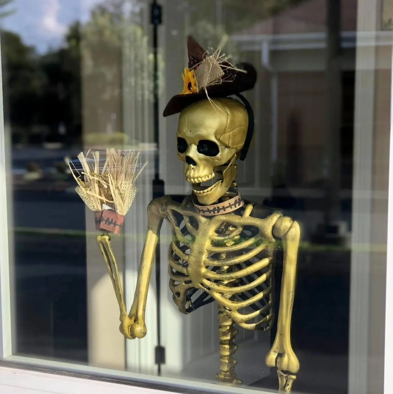 Skully, The Goines Agency mascot, dressed in a festive hat outside the office.